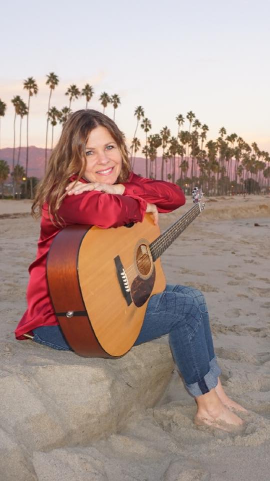 Jennifer with guitar at the beach